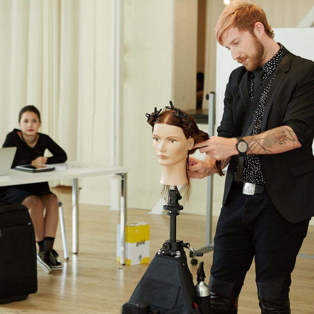 Pivot Point instructor demonstrating hairstyle techniques